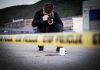 Gang Violence HORROR: Stockton Birthday Party Massacre Crime scene photographer behind police tape with evidence marker.