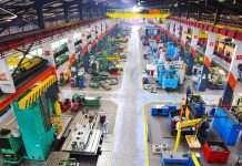 Locals REVOLT Over Massive Tech Project Aerial view of a large industrial workshop filled with various machinery and equipment