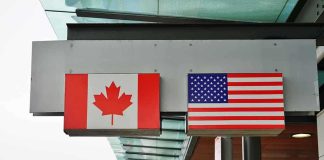 Alberta Breakaway Push Underway Canadian and American flags displayed at a border crossing