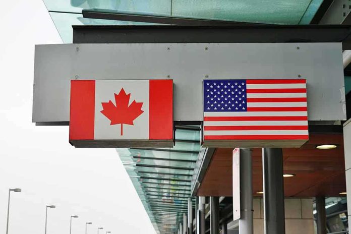 Canadian and American flags displayed at a border crossing