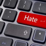 Close-up of a keyboard with a red key labeled Hate