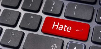 Close-up of a keyboard with a red key labeled Hate