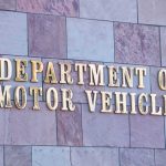 New RV Law Just Backfired Sign for the Department of Motor Vehicles on a stone wall