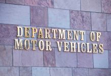 New RV Law Just Backfired Sign for the Department of Motor Vehicles on a stone wall