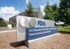 FDA BLOCKS Moderna Flu Vaccine — RFK Strikes FDA building sign with blue sky background.