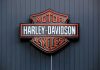 Harley Stock CRUSHED After Grim Outlook Harley-Davidson Motor Cycles logo on dark wall.