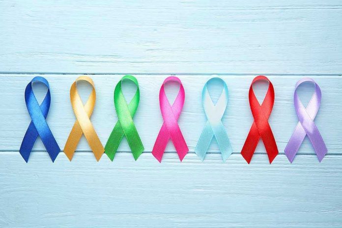 1564226551 Colorful awareness ribbons on light wooden background.