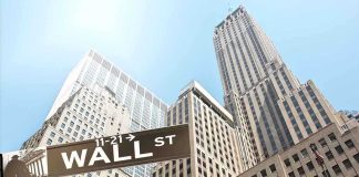 Blockbuster Earnings INCOMING — Wall Street Completely Unprepared Street signs for Wall Street and Broad Street with skyscrapers in the background