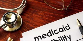 Feds FREEZE $1.3B – Is California’s System RIGGED? Stethoscope pen document about Medicaid eligibility on table