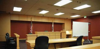 Hunter Biden’s Shocking Prostitution Claims Exposed Interior view of an empty courtroom with wooden furniture and American flags