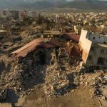 Cityscape with collapsed buildings and rubble after earthquake