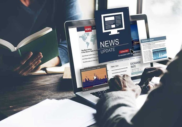 Person reading news on a laptop.