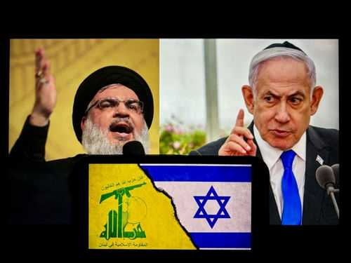 israel-hezbollah-2507616187 Two men with conflicting flags between them.