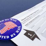 Mail-in ballot application with I Voted By Mail sticker.