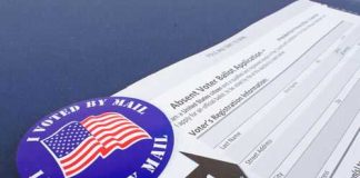 Mail-in ballot application with I Voted By Mail sticker.