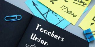 A black notebook with 'Teachers Union' written on it, surrounded by colorful sticky notes and paper clips