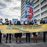 Group of activists holding a banner at a protest event