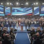 The Democratic Party Just Took Another Radical Left Turn A political convention with speakers on stage and a cheering crowd holding signs and flags
