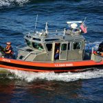 U.S. Coast Guard patrol boat speeding across the water