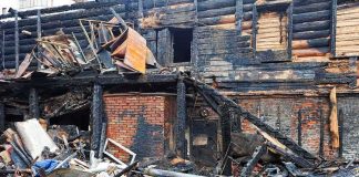 Arson Hits Again: Beloved Church Torched Burned building facade with charred debris