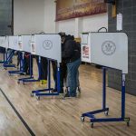 What the Federal Government Is Trying to Do with State Voter Rolls Voters at polling booths in a gymnasium