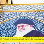 Wounded Ruler Rumors Jolt Pentagon Mural of Ali Khamenei with decorative background and text