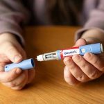 ‘Zombie Filler’ Is the Latest Bizarre Ozempic Trend Hands holding an Ozempic injection pen.