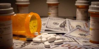 Are Drugs Actually Flowing Out of America Instead of In? Prescription pill bottle and white tablets on scattered US dollar bills