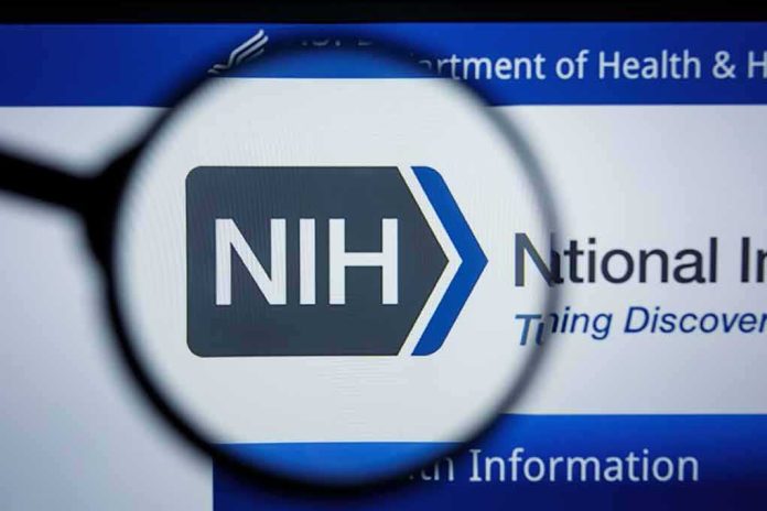 shutterstock_1454623682 Magnifying glass focuses on NIH logo on a website