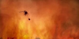 Wildfire Chaos: Ex-Con Tagged At Ignition Point Helicopter fights massive wildfire over burning forest