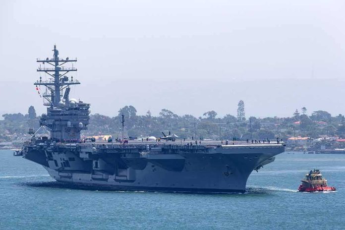 shutterstock_1926504035 Aircraft carrier escorted by a tugboat in a harbor