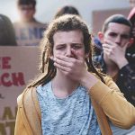 Ohio Teens Target the Ballot Box Protester covering mouth during rally