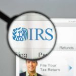 IRS Crackdown Teased — But Here’s The Catch Magnifying glass highlighting IRS logo on a website