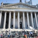 U.N. Report Finds ‘Reasonable Grounds’ for U.S. War Crimes Courthouse facade with media crews setting up outside.