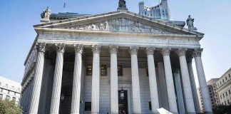 U.N. Report Finds ‘Reasonable Grounds’ for U.S. War Crimes Courthouse facade with media crews setting up outside.