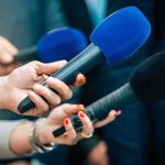Hidden Camera EXPOSES Cash-For-Votes Scandal! Reporters holding colorful microphones