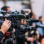 AOC Is Betting on SOCIALISM for 2028 Video cameras on tripods at a media event