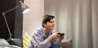Your Smart TV is SPYING on You! Teen in pajamas playing video games on a couch