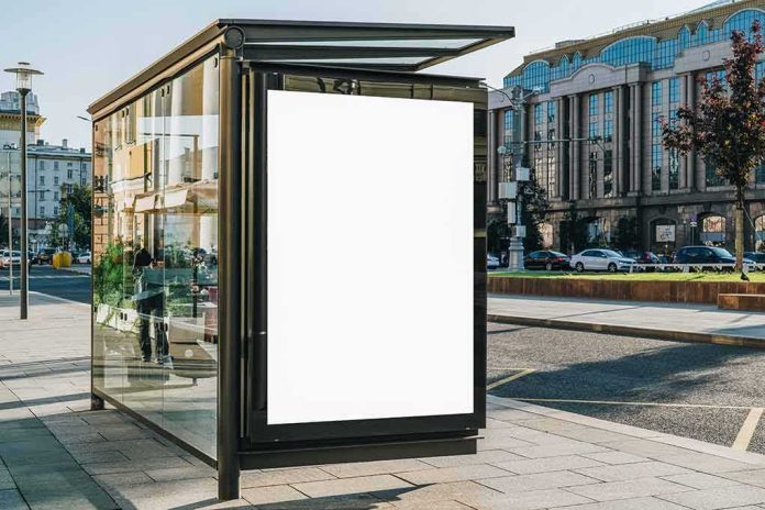 bus stop shelter with blank advertisement poster in city street