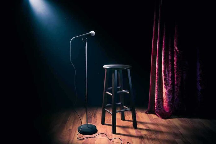 shutterstock_1031487514 Microphone on stand beside stool under spotlight on stage