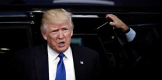 Trump’s Would-Be Assassin Shopped Under THIS Name man in suit stepping out of a vehicle