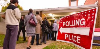 Voters standing in line outside a polling place