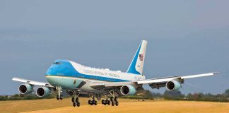 Airplane landing on runway with landing gear extended