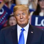 Trump Turns The Screws On Zelenskyy Donald Trump at a rally wearing a dark suit and blue tie