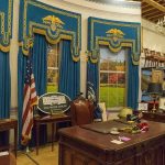 Summoned Mid-Tarmac — What Did Patel Do? Oval Office-style desk and decor in a museum display