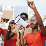 Trans Kids Debate IGNITES Texas Politics! Protester with megaphone leading a crowd