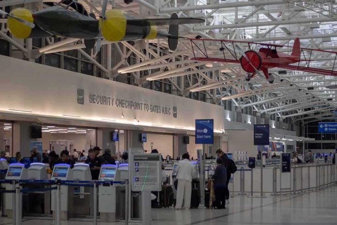 shutterstock_1332557678-1 airport security checkpoint with passengers and hanging vintage airplanes