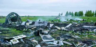 Aircraft crash debris scattered across a grassy field