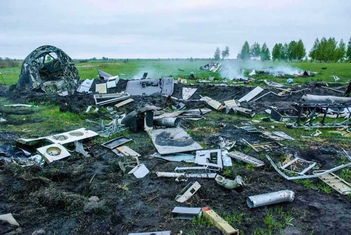 Aircraft crash debris scattered across a grassy field