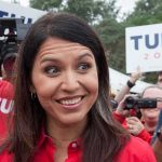 Tulsi Gabbard OUT, Thanks Trump Tulsi Gabbard smiling at an outdoor event surrounded by supporters